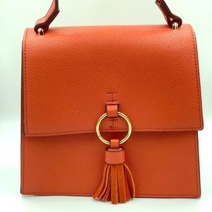 Top handle orange purse with cross body strap